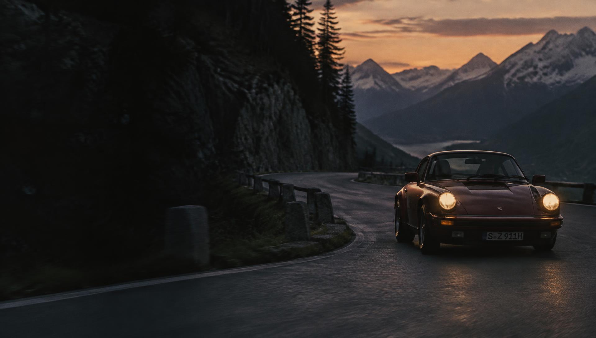 Classic sports car on a mountain road at dusk